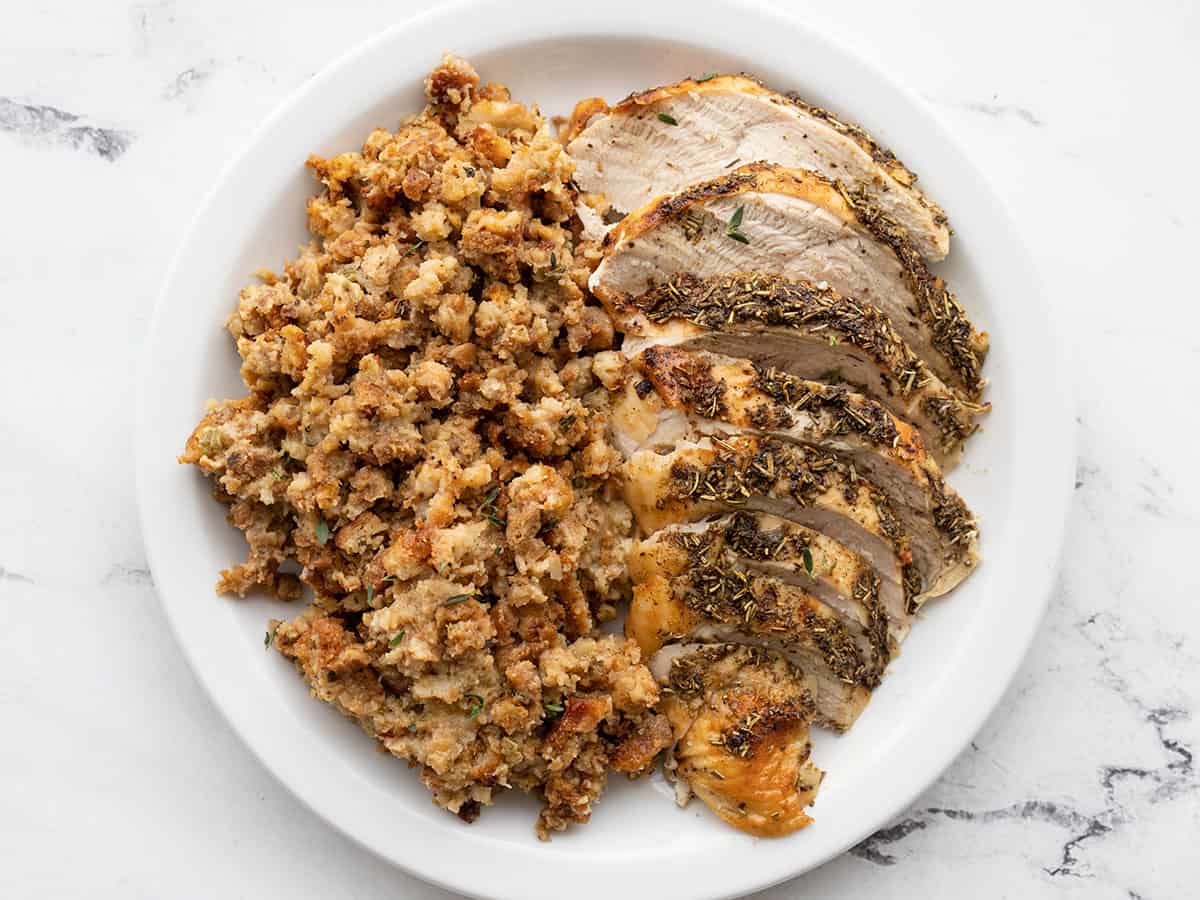 Sliced roasted turkey and stuffing on a plate