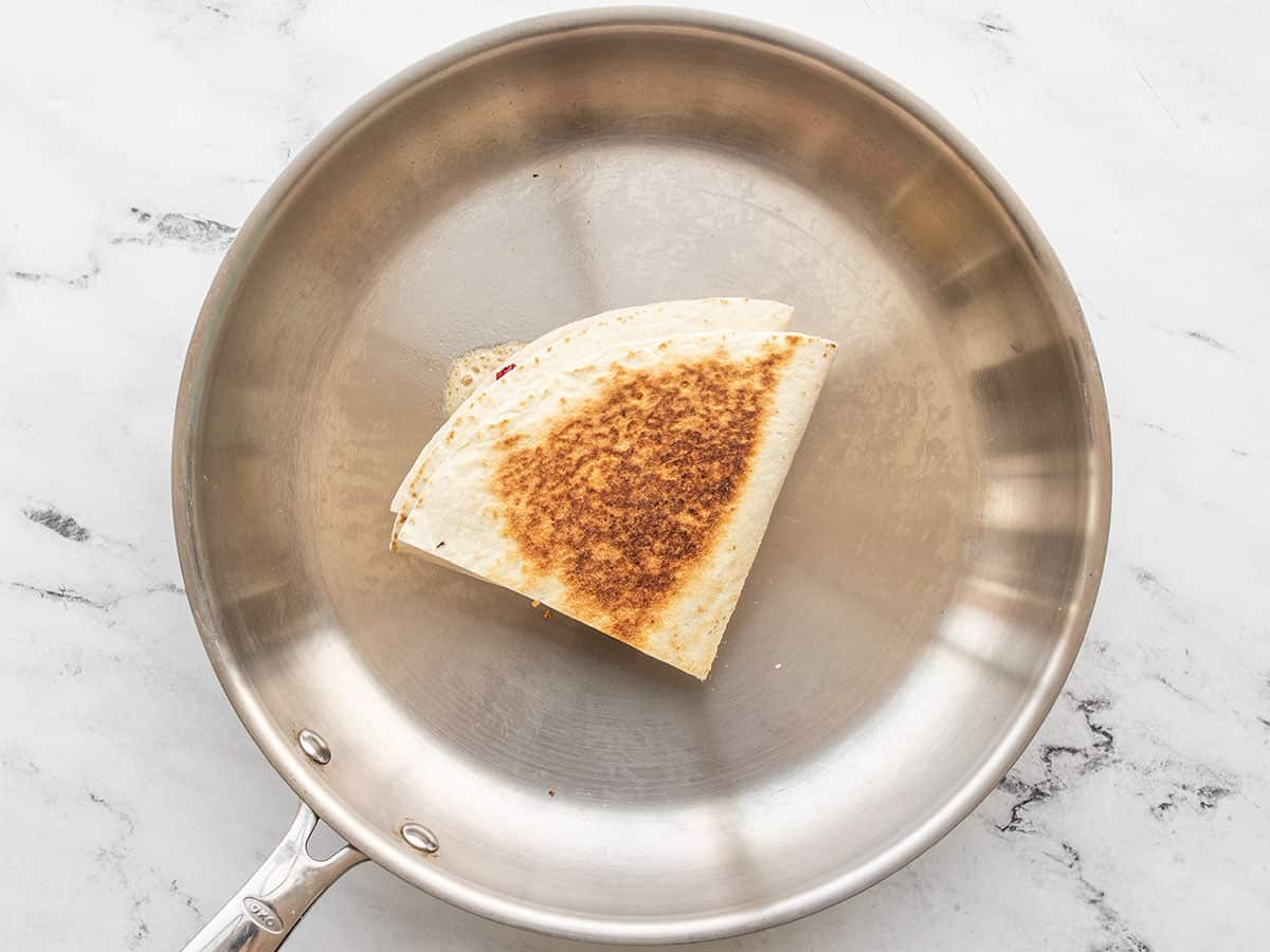 Browned tortilla wrap in the skillet