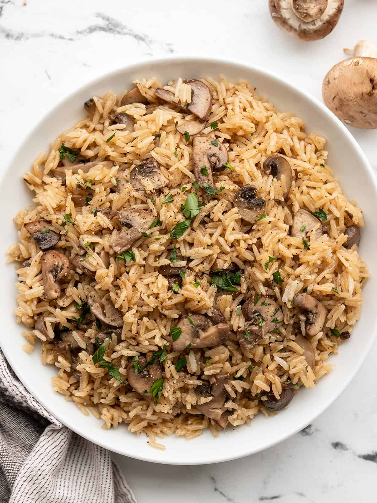 Mushroom rice in a white serving bowl