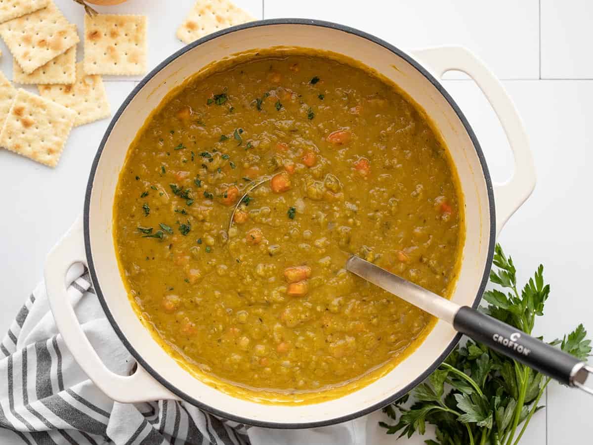 Finished split pea soup in the pot with a ladle