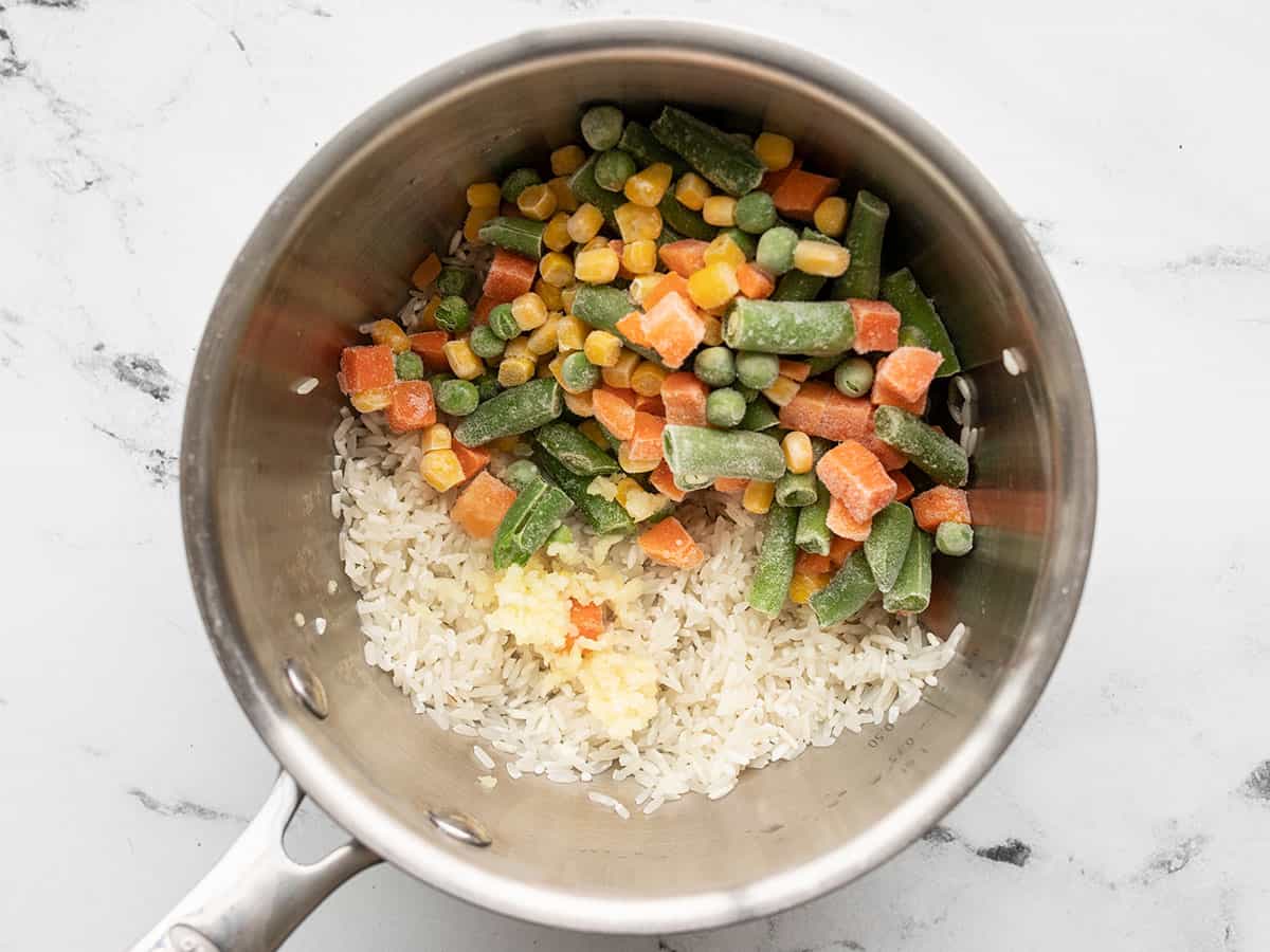 Rice, vegetables, and garlic in a pot