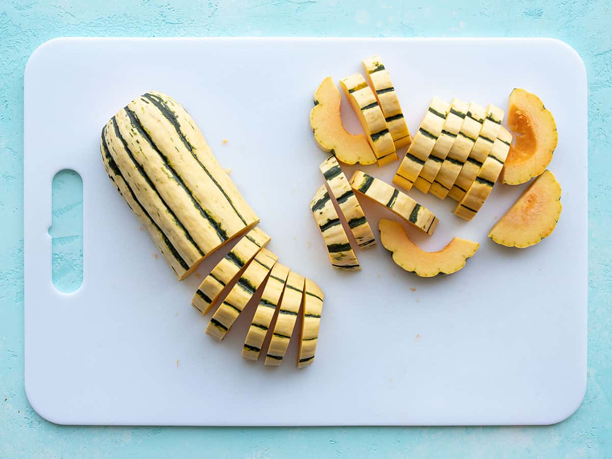 Sliced delicata squash on a cutting board