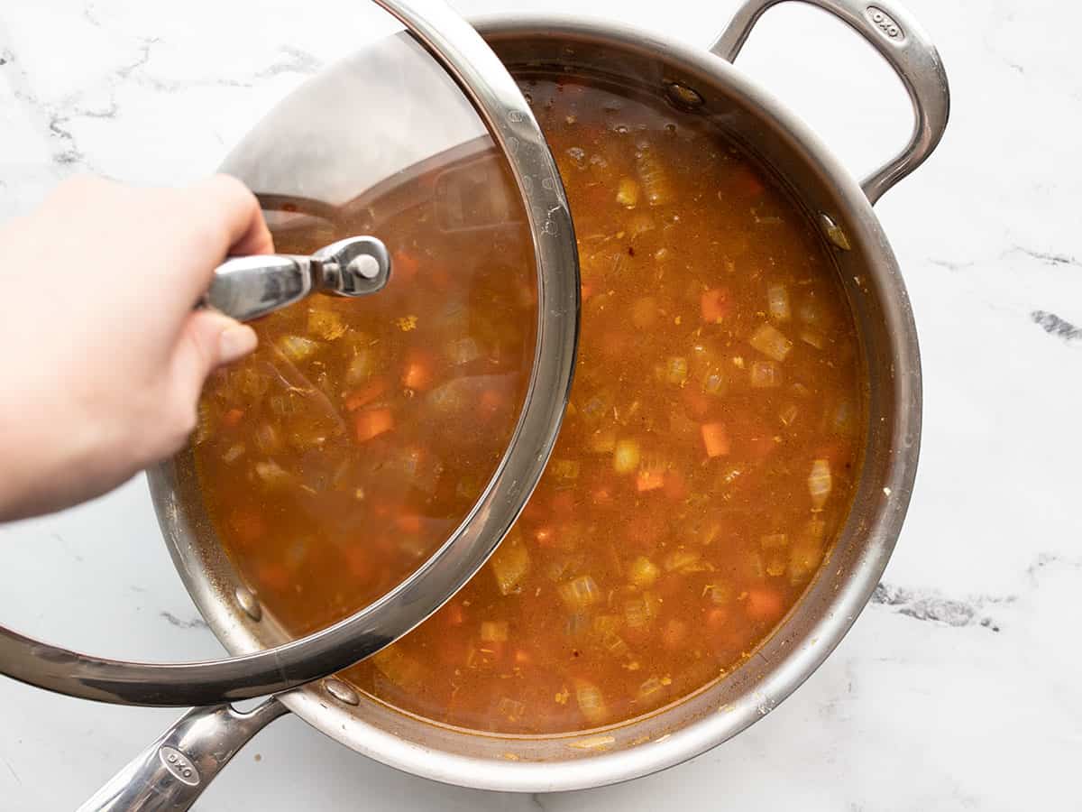 Lid being placed on the skillet