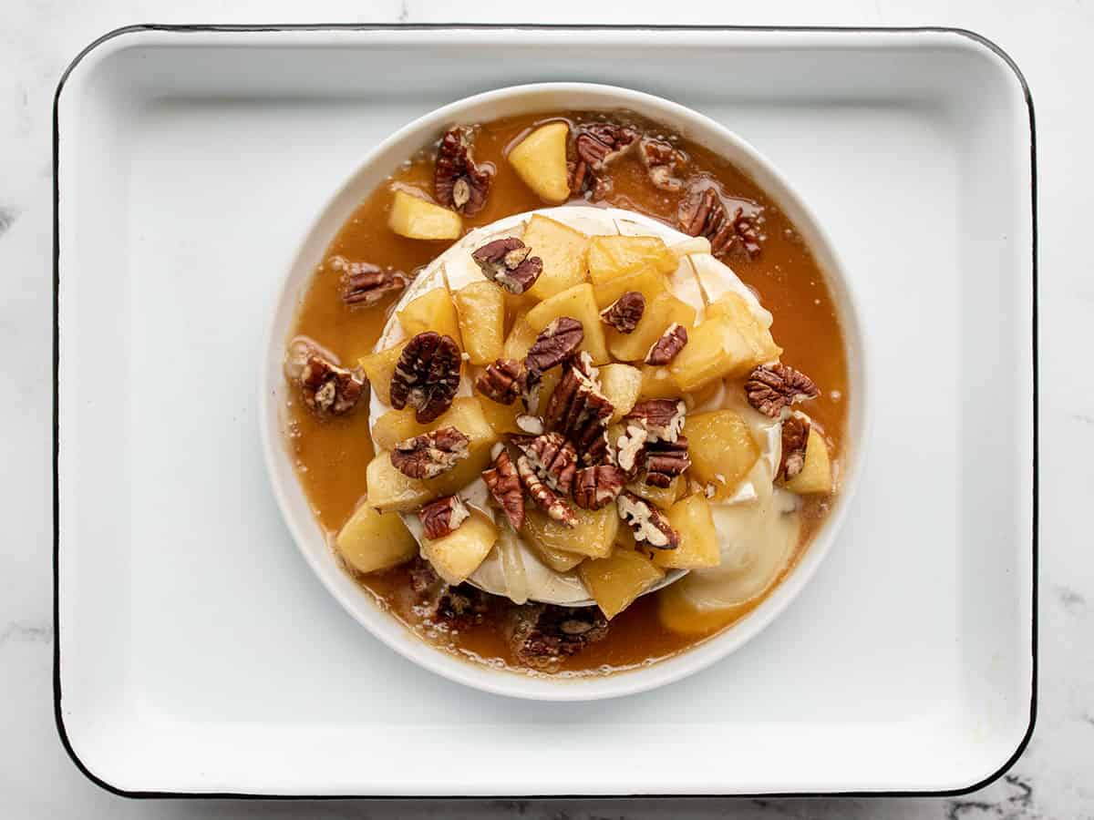 Caramelized apples poured over brie, topped with nuts
