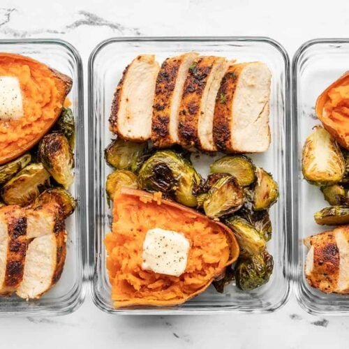 lineup of meal prep containers with chicken, brussels sprouts, and sweet potatoes