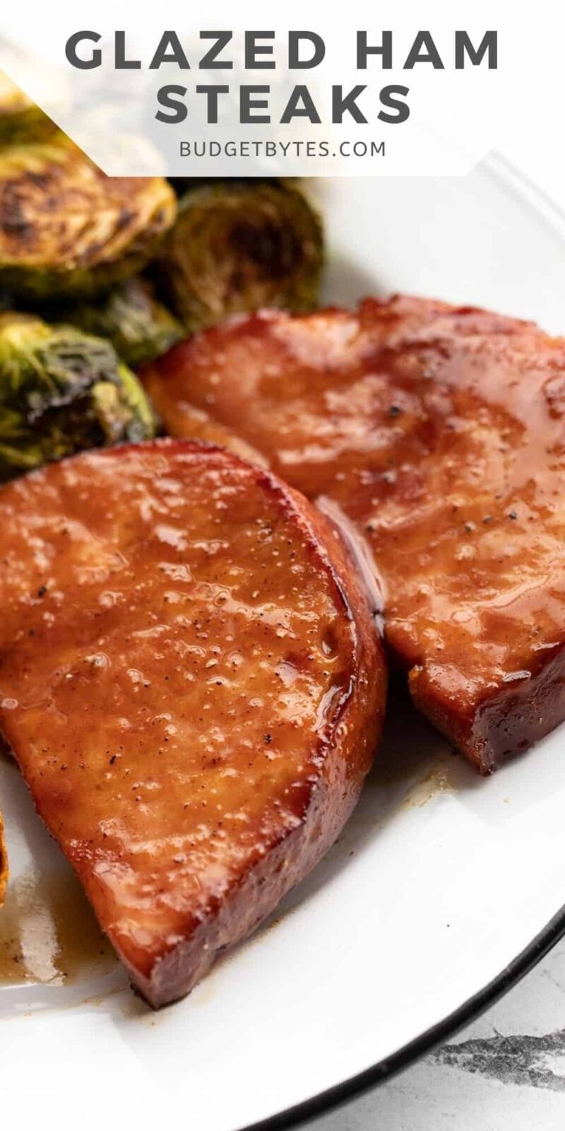 side view of glazed ham steaks on a plate, title text at the top