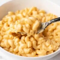 side view of macaroni and cheese in a bowl with a fork
