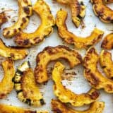 Close up view of roasted delicata squash on the baking sheet