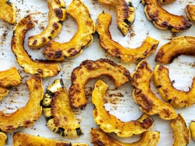 Close up view of roasted delicata squash on the baking sheet