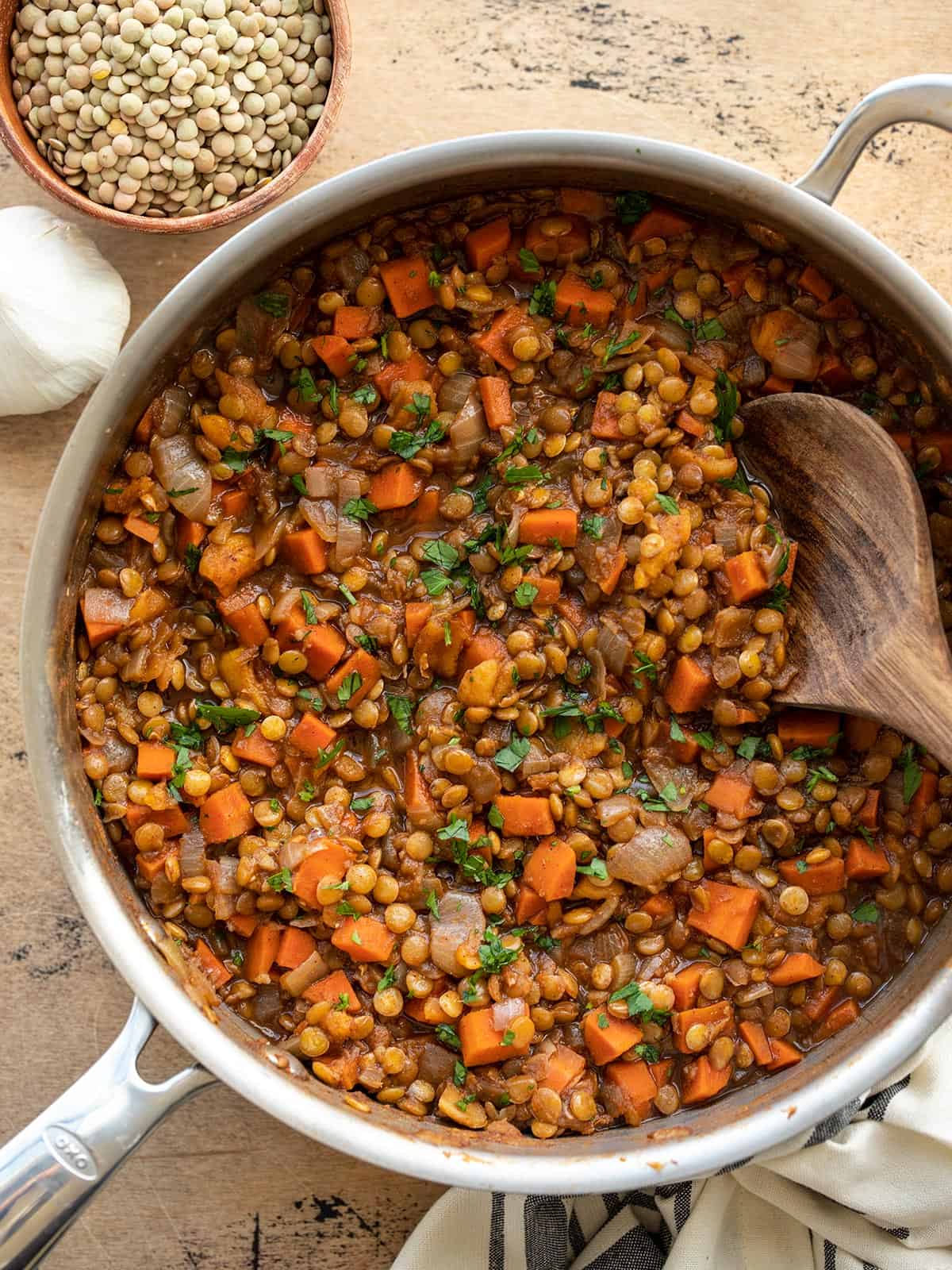 Overhead view of spiced lentils with carrots in a skillet