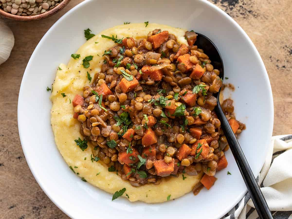 Overhead view of spiced lentils over a bed of polenta