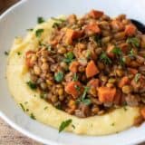 side view of spiced lentils on a bed of polenta