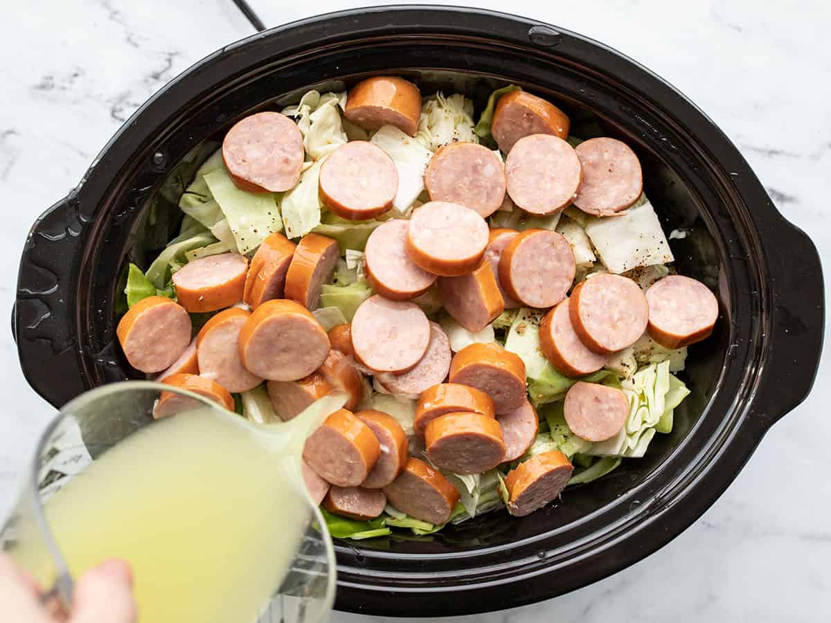 sausage and broth added to the slow cooker