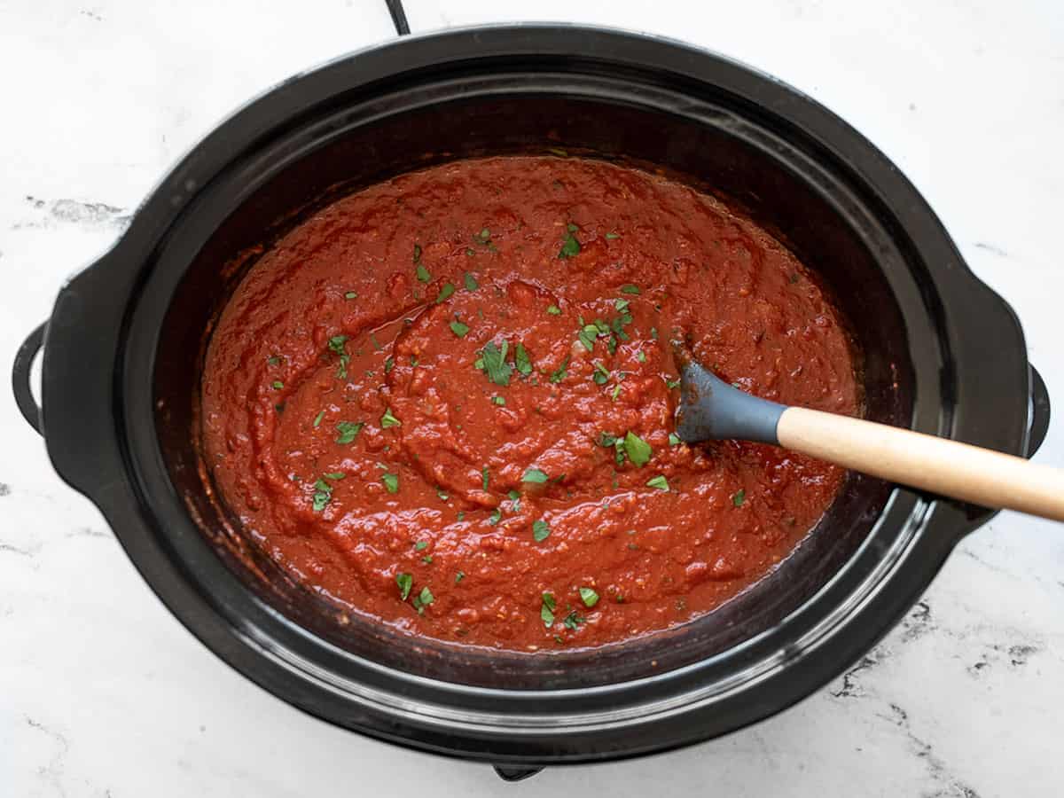 Finished pasta sauce in the slow cooker garnished with parsley