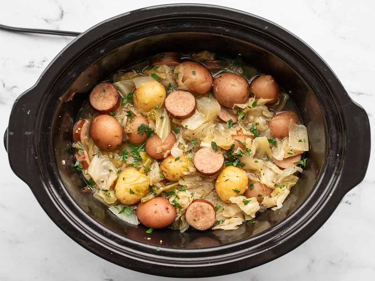 Stirred cabbage, sausage, and potatoes in the slow cooker