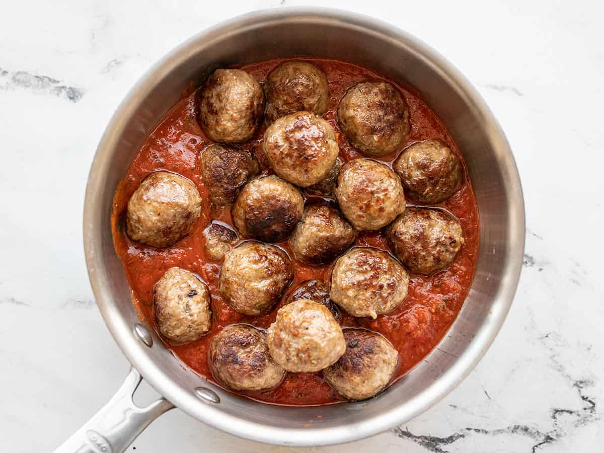 Meatballs in a pot of red sauce