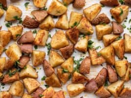 close up of parmesan roasted potatoes garnished with parsley