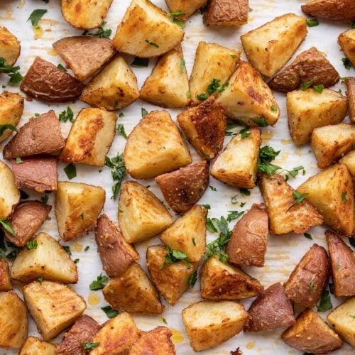close up of parmesan roasted potatoes garnished with parsley