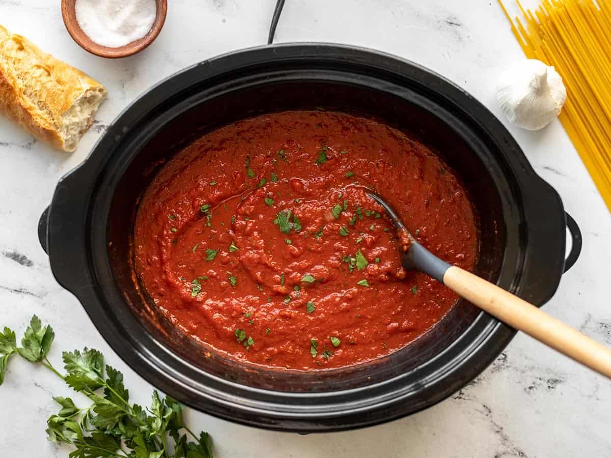 Pasta sauce in a slow cooker garnished with parsley