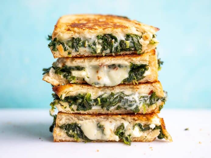 A stack of spinach and feta grilled cheese sandwiches