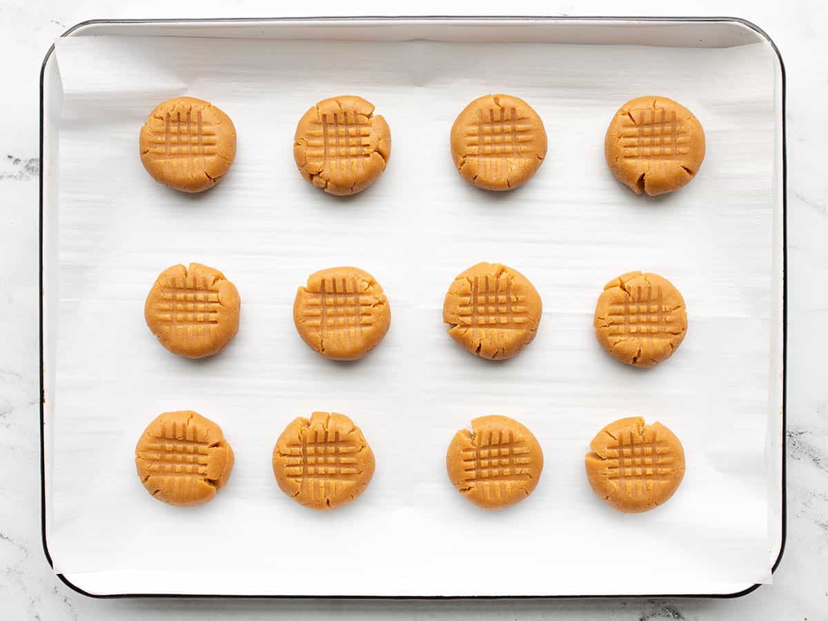 unbaked peanut butter cookies on a baking sheet