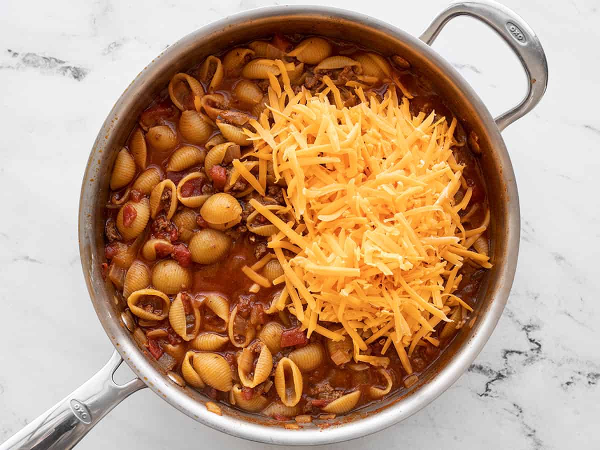 shredded cheddar added to the skillet