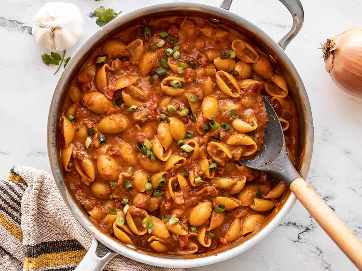 beef taco pasta in the skillet with a spoon