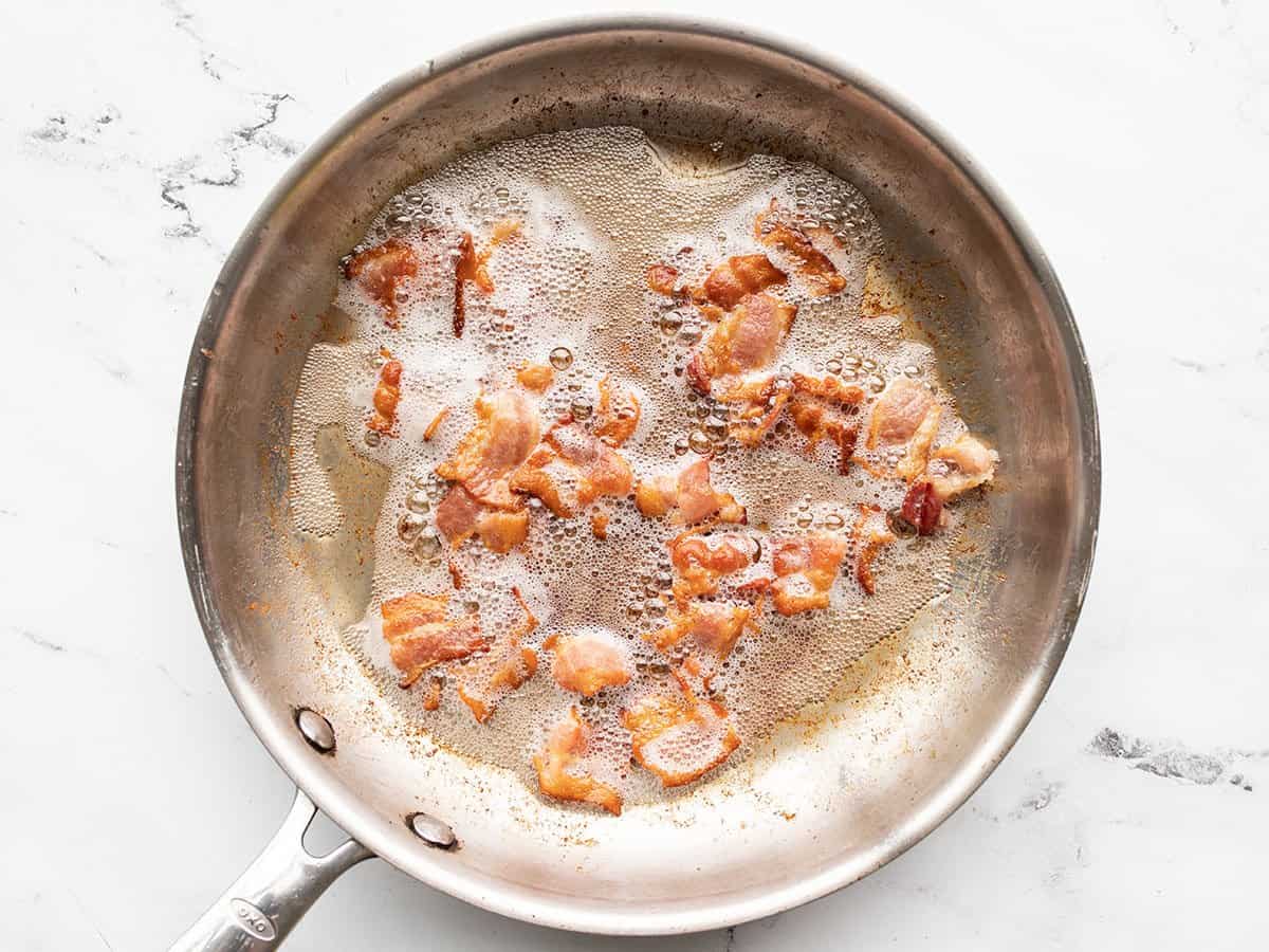 Cooking bacon in a skillet.