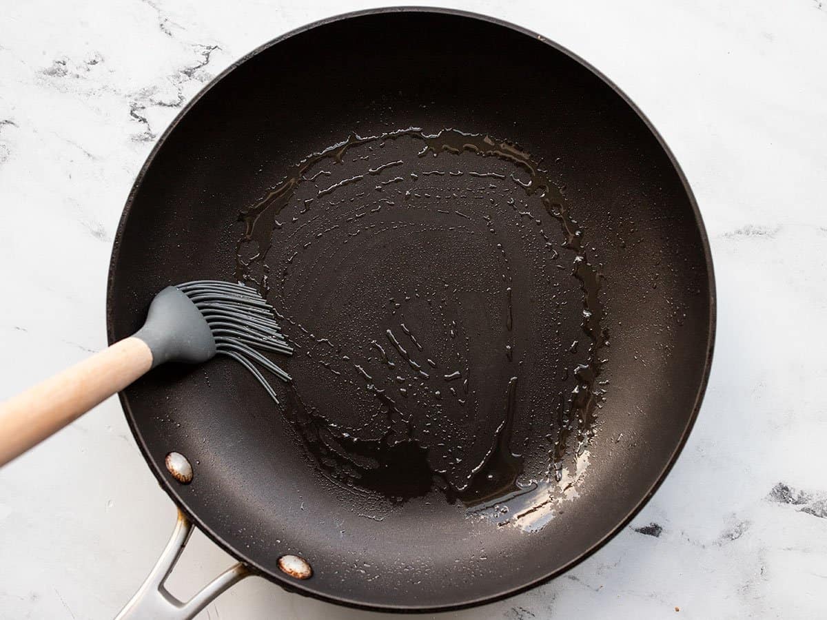 Oil being brushed onto a skillet.