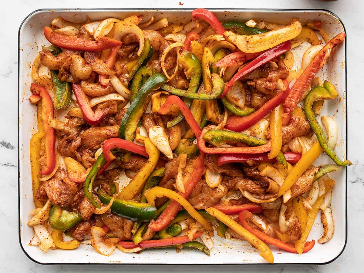 Seasoned chicken and vegetables ready to go into the oven