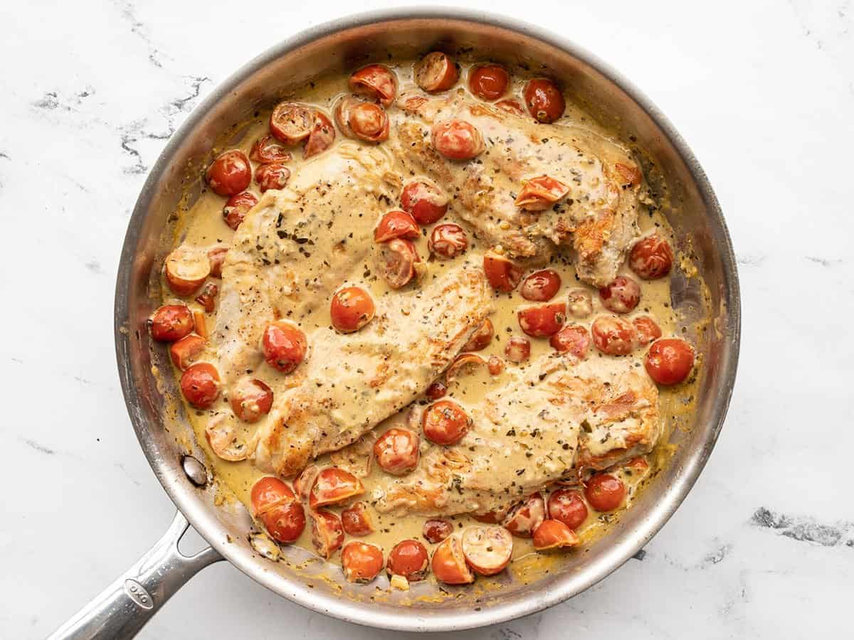 Chicken added back to the skillet with the creamy basil sauce.