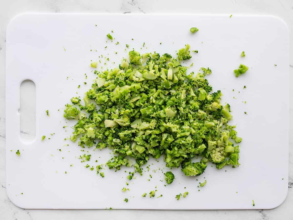 Chopped broccoli on a cutting board.