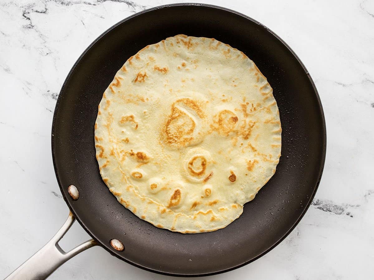 golden brown flipped crepe in the skillet.