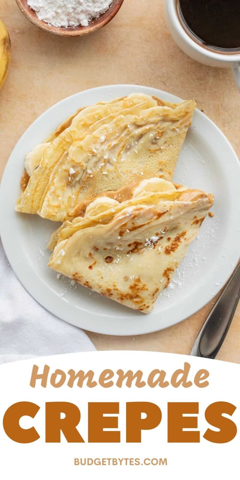 Two filled and folded crepes on a plate from above.