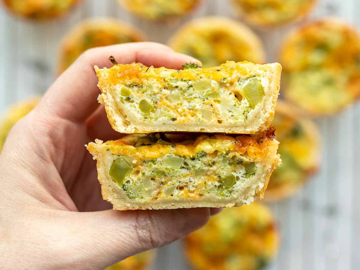 Side view of a mini broccoli cheddar quiche cut in half.