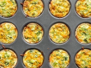 mini broccoli cheddar quiches in a muffin tin.