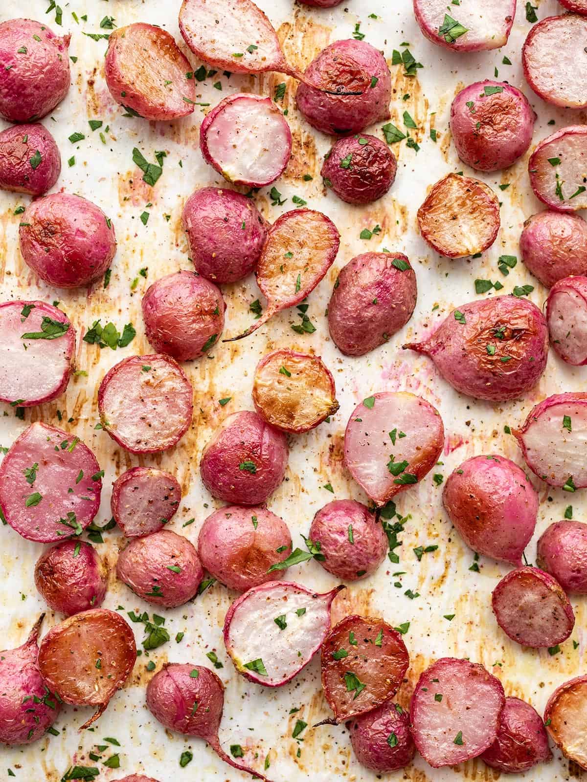 overhead view of roasted radishes on the baking sheet.