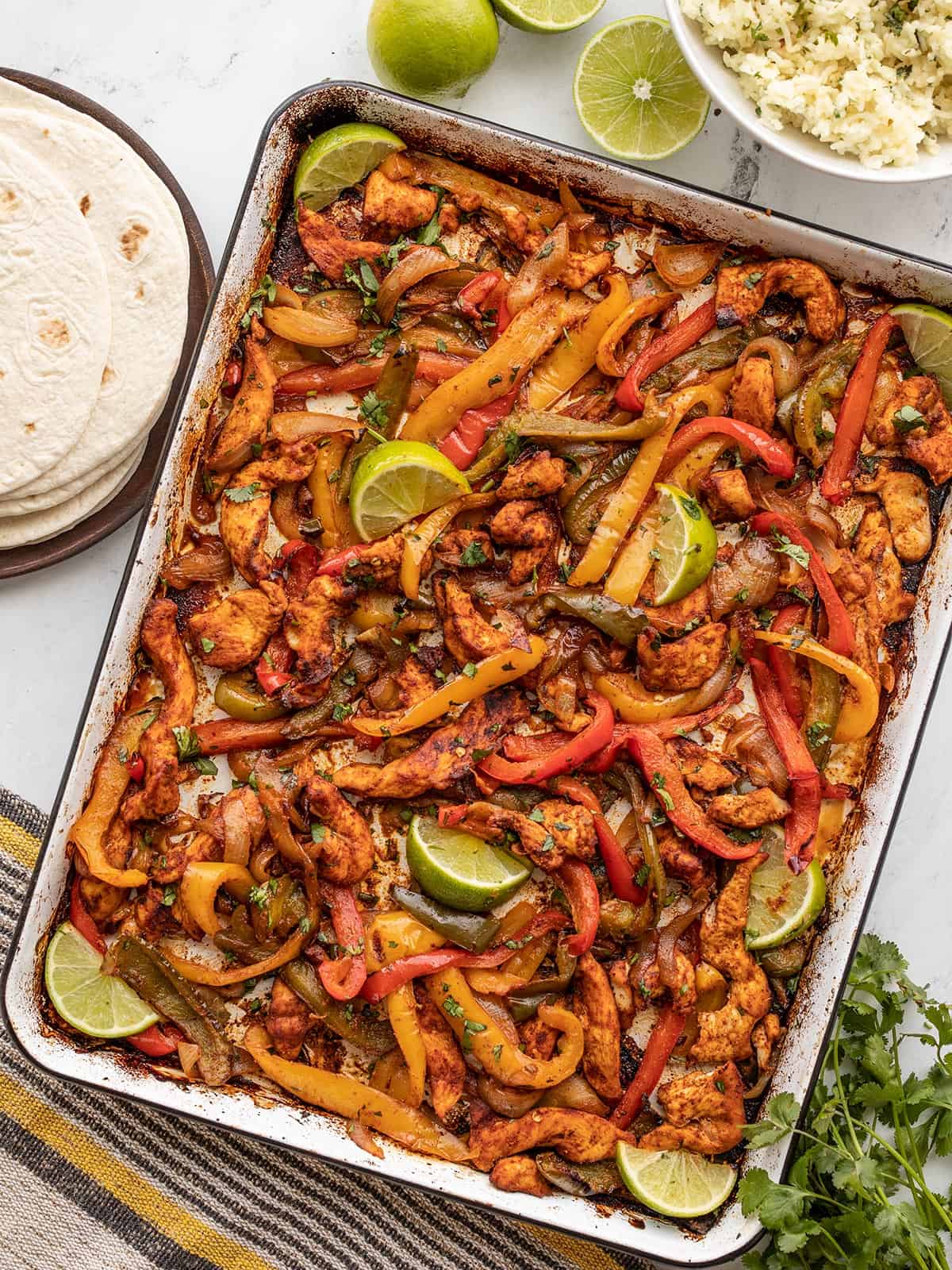 A sheet pan full of fajita chicken, onions, and peppers