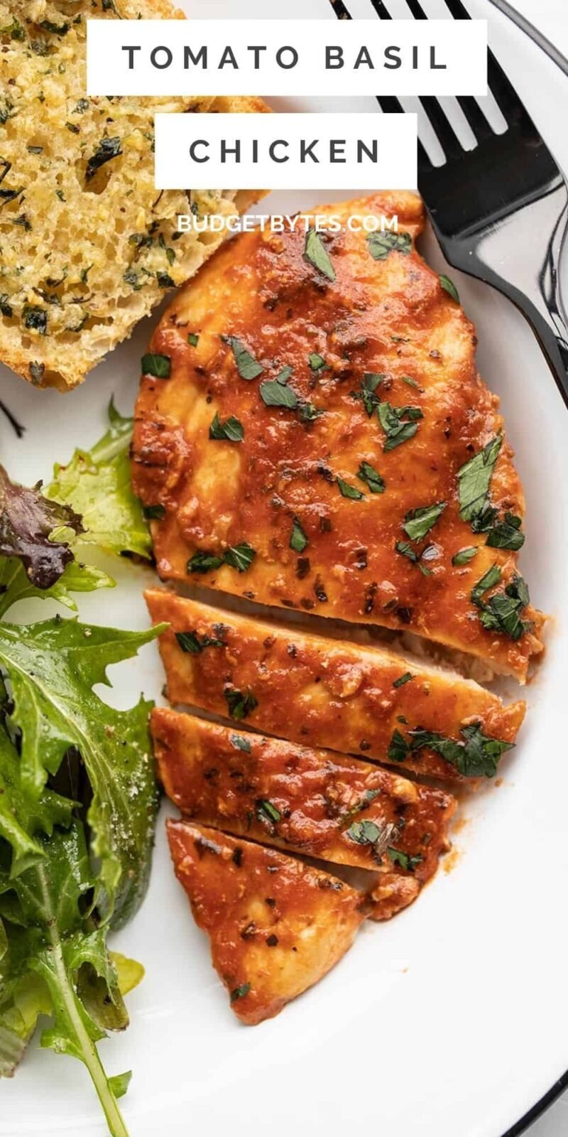 close up of sliced tomato basil chicken on a plate, title text at the top.