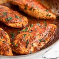 Side view of tomato basil chicken in the skillet