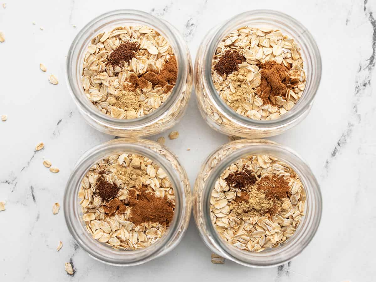 oats and spices added to jars, from above.