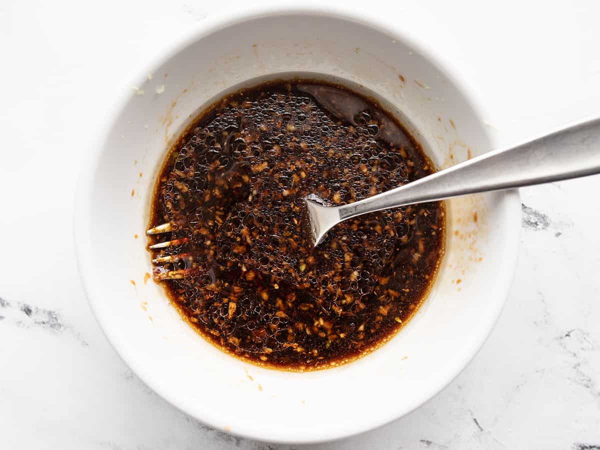 Teriyaki marinade in a bowl with a fork.