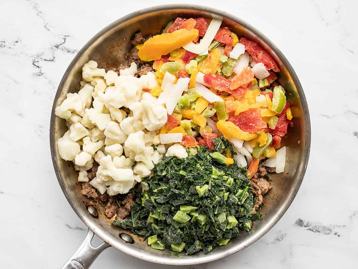 Frozen vegetables added to the skillet.