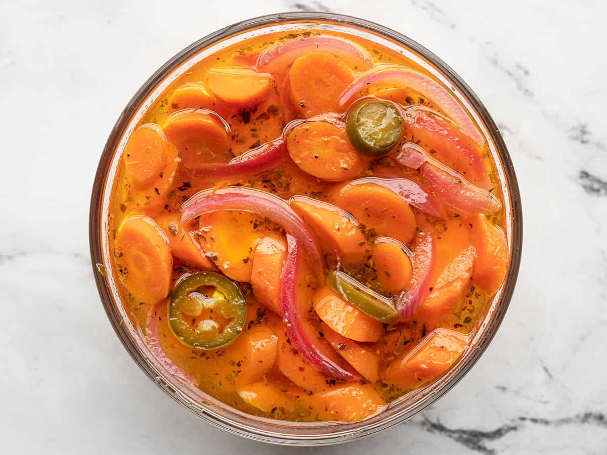 Pickled carrots in a glass bowl.