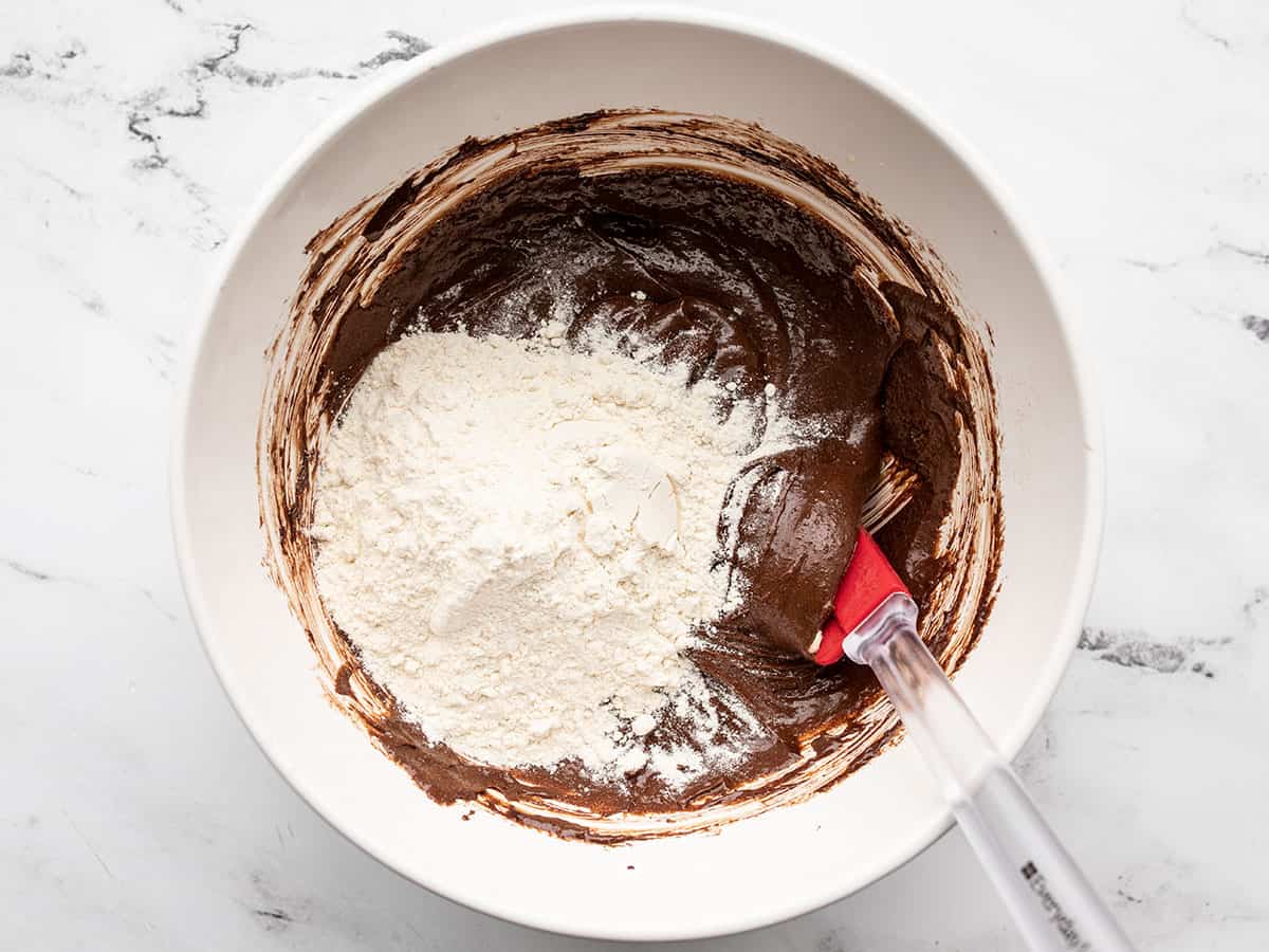 flour added to the bowl of brownie batter.