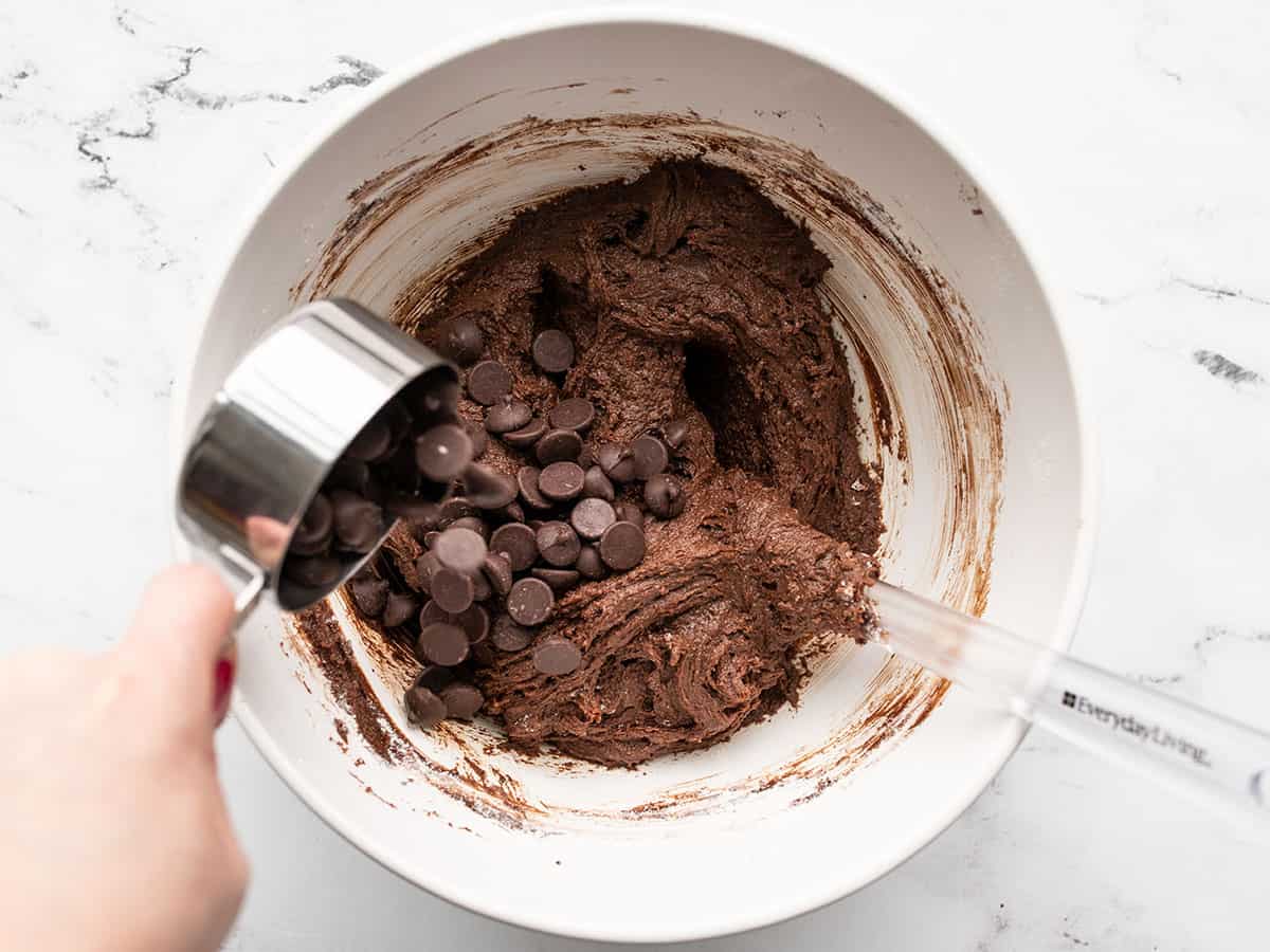 chocolate chips being added to the brownie batter.