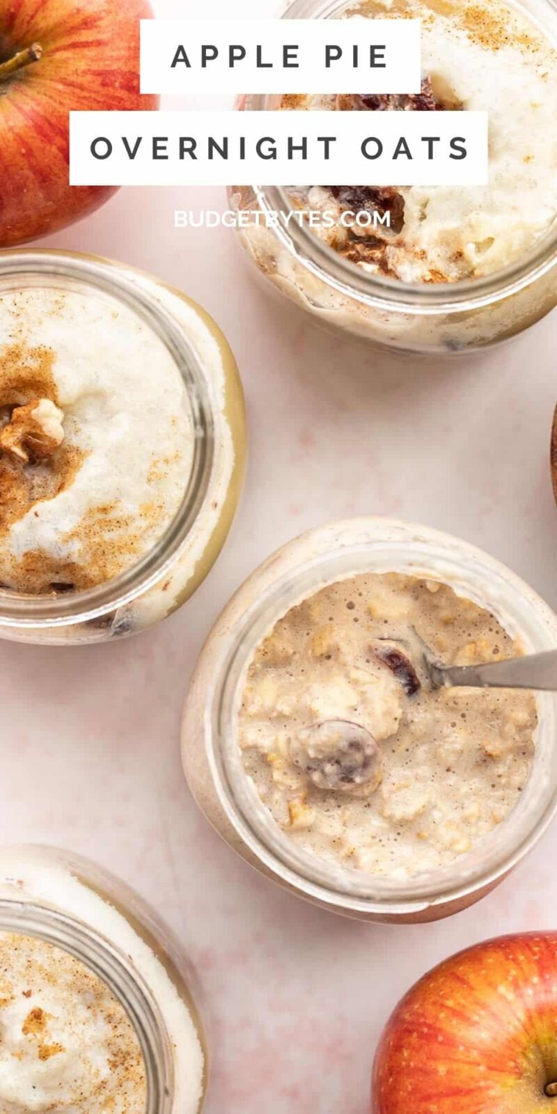 Overhead view of four jars of apple pie overnight oats.