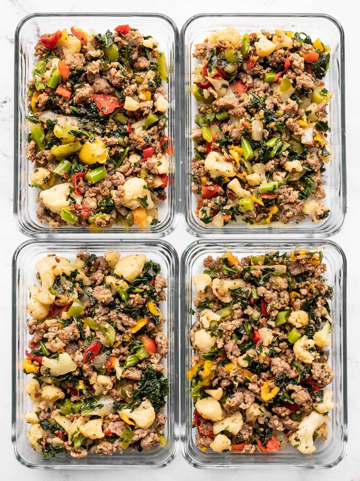 Sausage and vegetable skillet in glass meal prep containers.