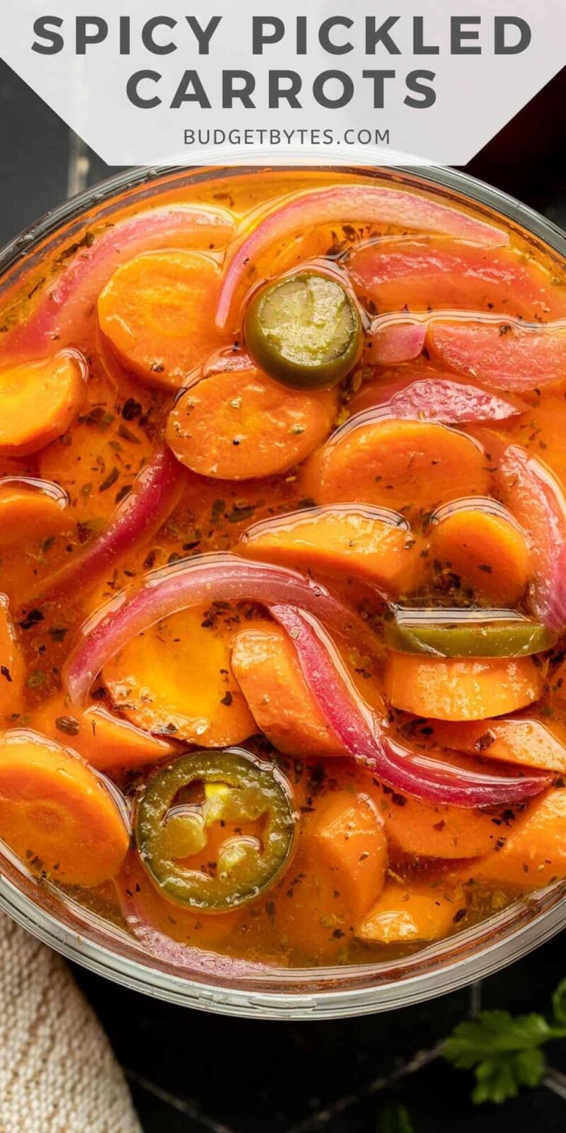 Close up overhead view of spicy pickled carrots in a bowl.