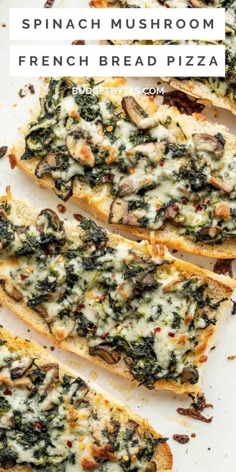 close up overhead view of spinach and mushroom french bread pizzas.